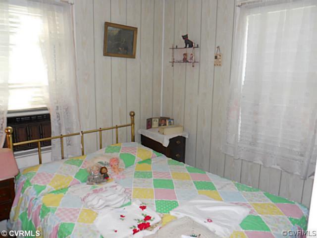 178 Buckner Road Bumpass, VA 23024 - Photo 9 of 16 a bedroom that has a bed and a table in it