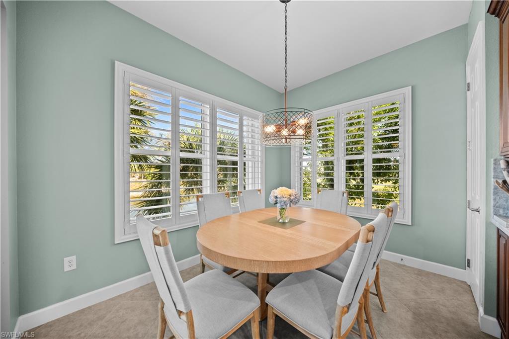 9220 Quartz Lane, Unit 202 Naples, FL 34120 - Photo 12 of 47 a view of a dining room with furniture window and outside view