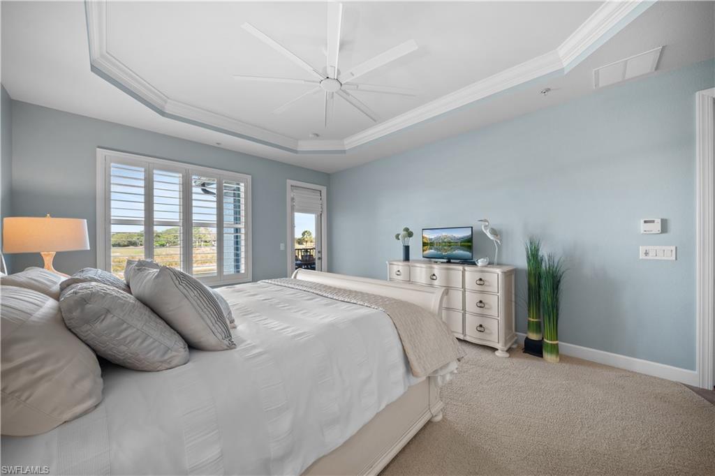 9220 Quartz Lane, Unit 202 Naples, FL 34120 - Photo 15 of 47 a spacious bedroom with a bed and a window