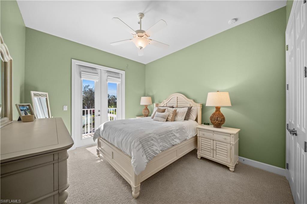 9220 Quartz Lane, Unit 202 Naples, FL 34120 - Photo 18 of 47 a bedroom with a bed and a table