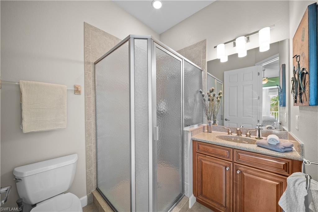 9220 Quartz Lane, Unit 202 Naples, FL 34120 - Photo 19 of 47 a bathroom with a sink a toilet and a mirror