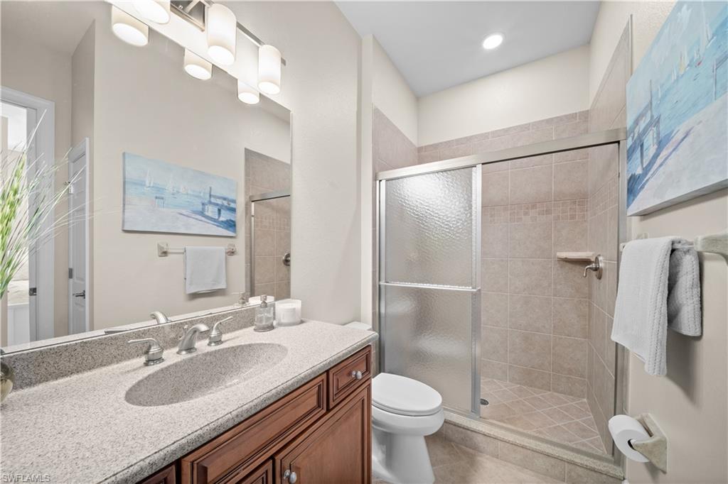 9220 Quartz Lane, Unit 202 Naples, FL 34120 - Photo 21 of 47 a bathroom with a sink toilet a mirror and shower