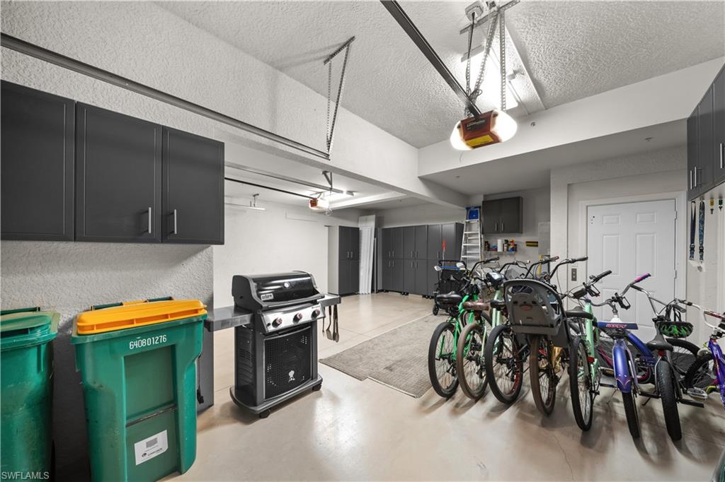 9220 Quartz Lane, Unit 202 Naples, FL 34120 - Photo 26 of 47 a kitchen with stainless steel appliances granite countertop a table chairs and a refrigerator
