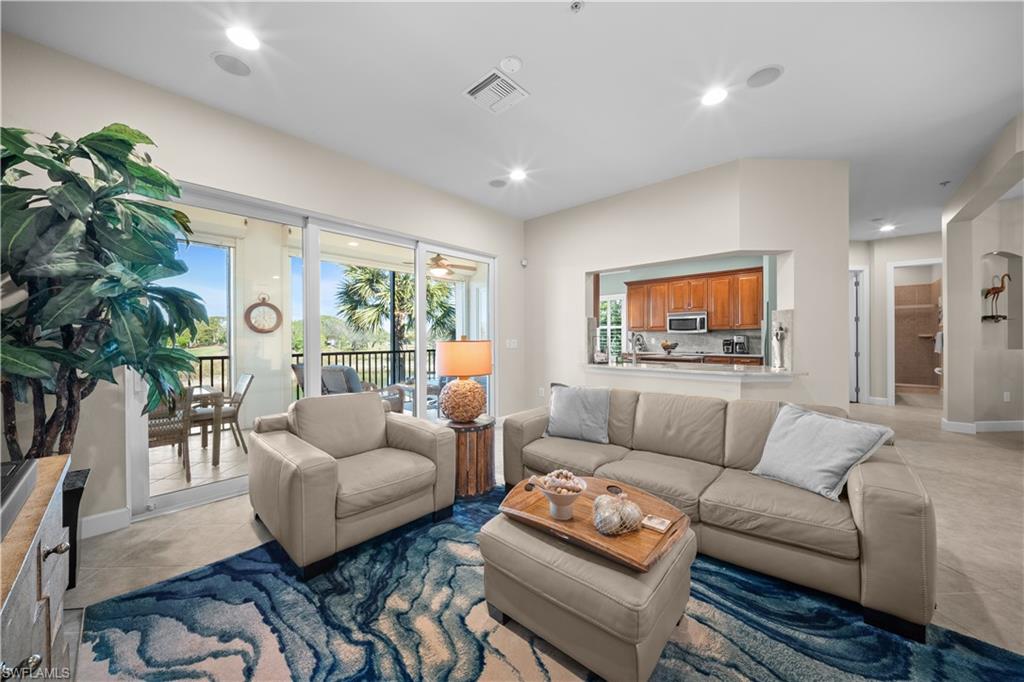 9220 Quartz Lane, Unit 202 Naples, FL 34120 - Photo 7 of 47 a living room with furniture and a large window