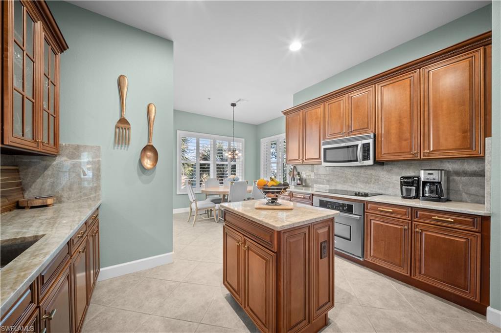 9220 Quartz Lane, Unit 202 Naples, FL 34120 - Photo 10 of 47 a kitchen with a sink stove and cabinets