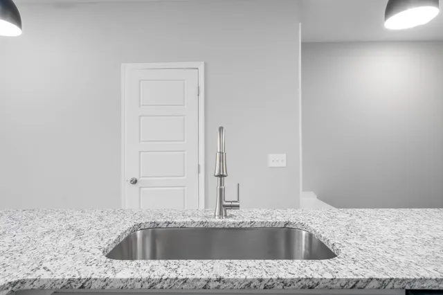 a bathroom with a granite countertop sink and mirror