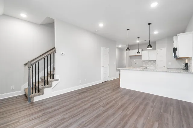 a view of kitchen with wooden floor and electronic appliances
