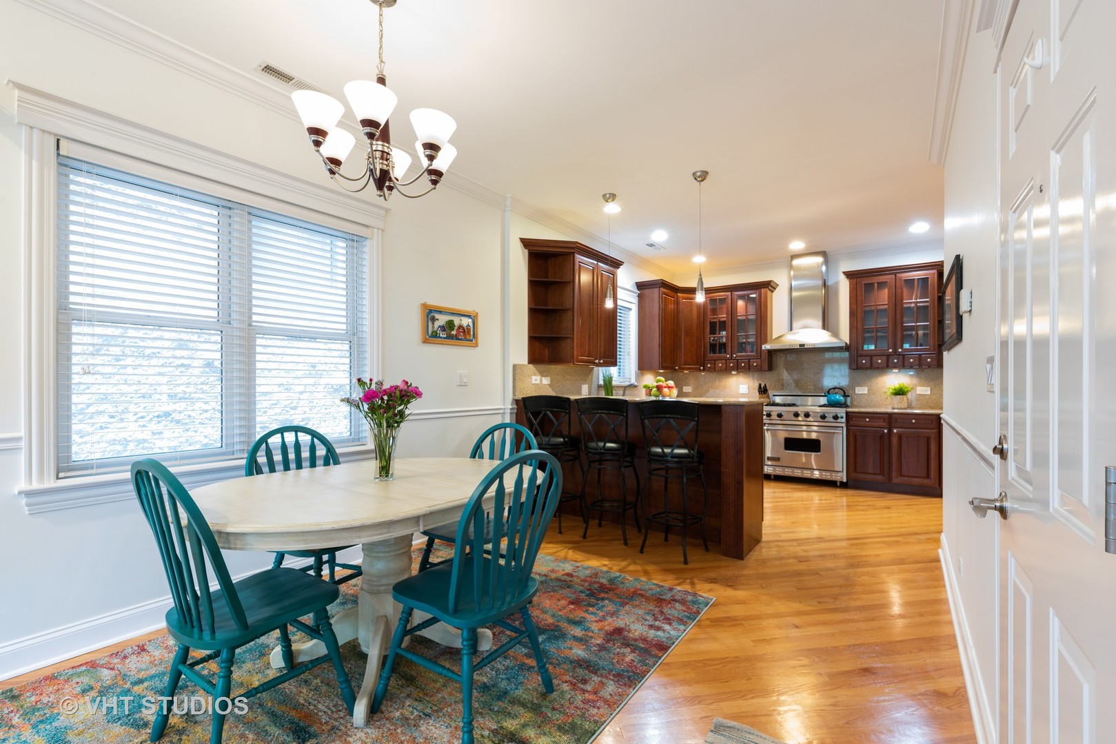 3535 North Reta Avenue, Unit 3 Chicago, IL 60657 - Photo 11 of 18 a view of a dining room with furniture and a chandelier
