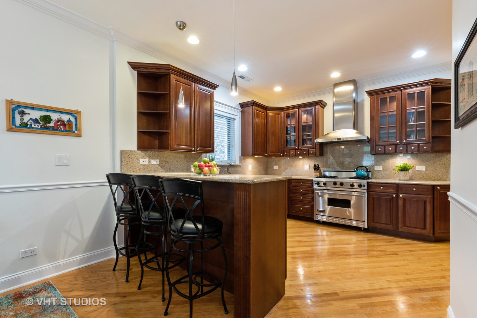 3535 North Reta Avenue, Unit 3 Chicago, IL 60657 - Photo 8 of 18 a kitchen with stainless steel appliances kitchen island granite countertop a stove a sink and a refrigerator