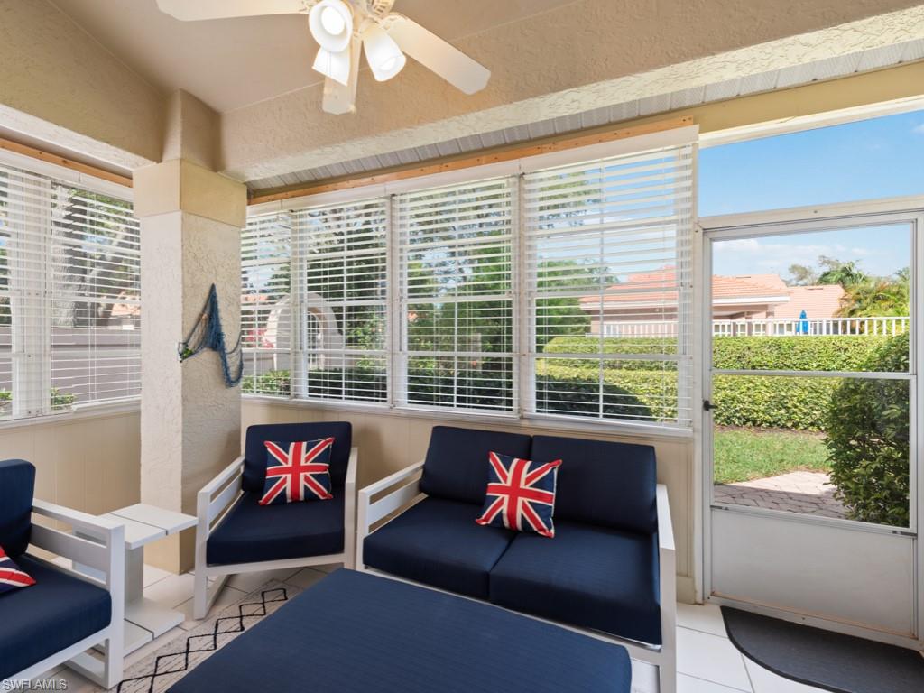 181 Napa Ridge Road East, Unit 35 Naples, FL 34119 - Photo 13 of 17 a living room with furniture and a large window