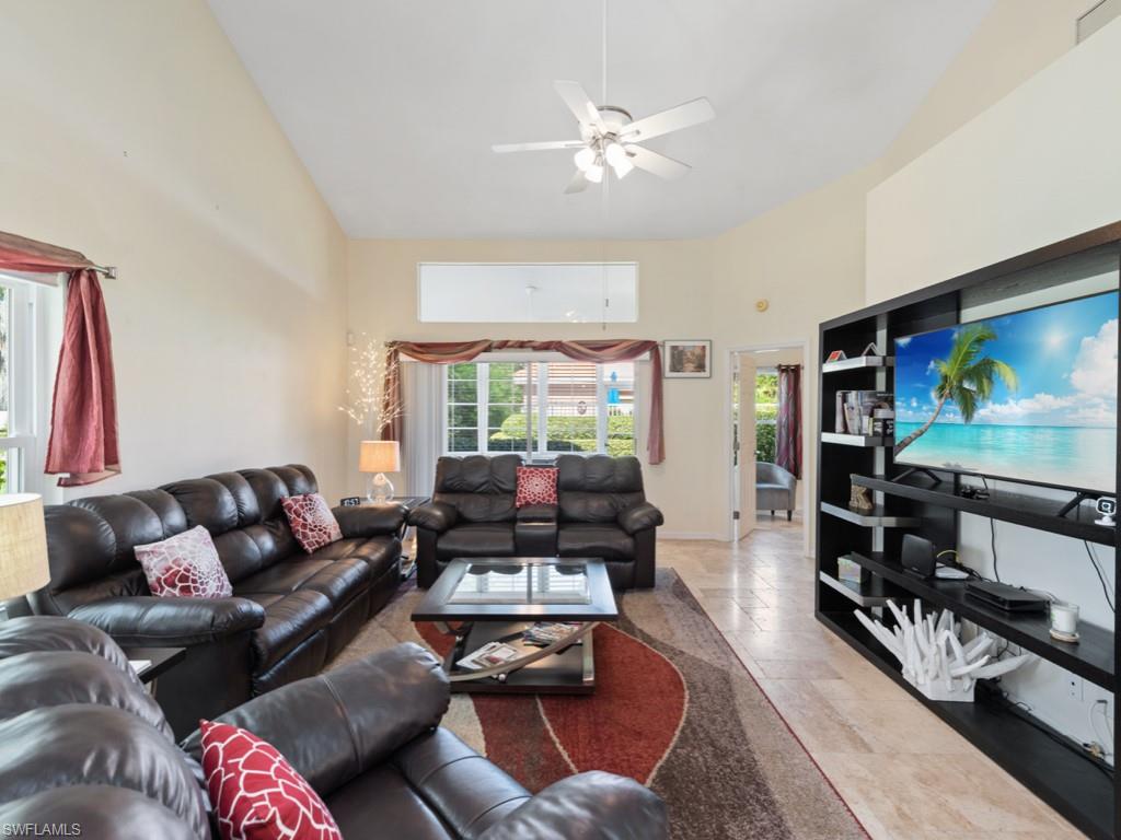 181 Napa Ridge Road East, Unit 35 Naples, FL 34119 - Photo 4 of 17 a living room with furniture and a flat screen tv