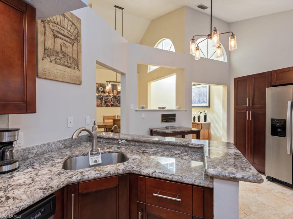 181 Napa Ridge Road East, Unit 35 Naples, FL 34119 - Photo 5 of 17 a kitchen with granite countertop a sink a counter top space and cabinets