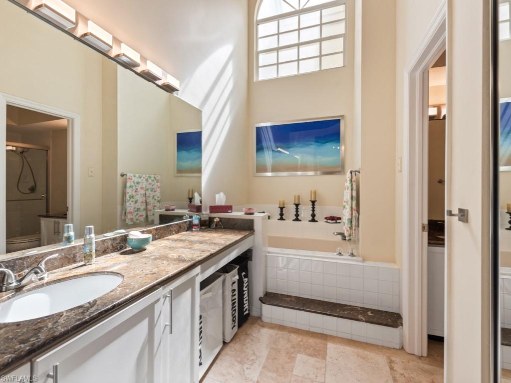 181 Napa Ridge Road East, Unit 35 Naples, FL 34119 - Photo 9 of 17 a bathroom with a sink double vanity and a bathtub