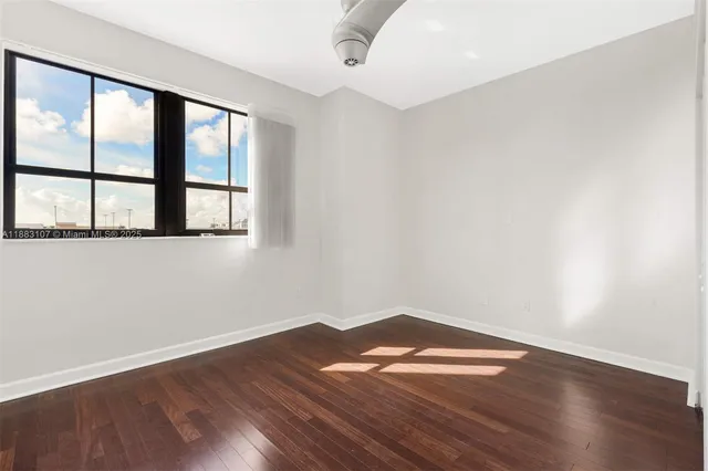 wooden floor in an empty room with a window