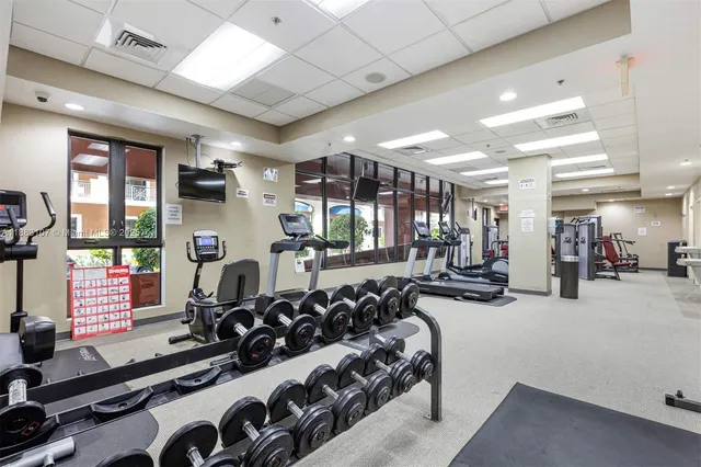 a room with gym equipment and a large window