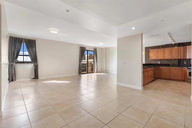 a view of kitchen with refrigerator and window