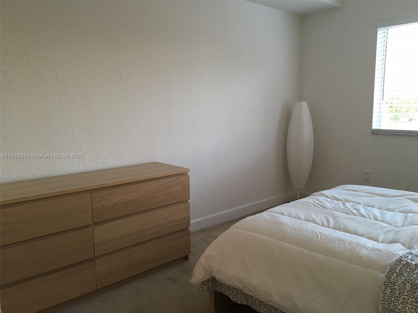 6001 Southwest 70th Street, Unit 525 South Miami, FL 33143 - Photo 5 of 14 a bedroom with a bed and a window