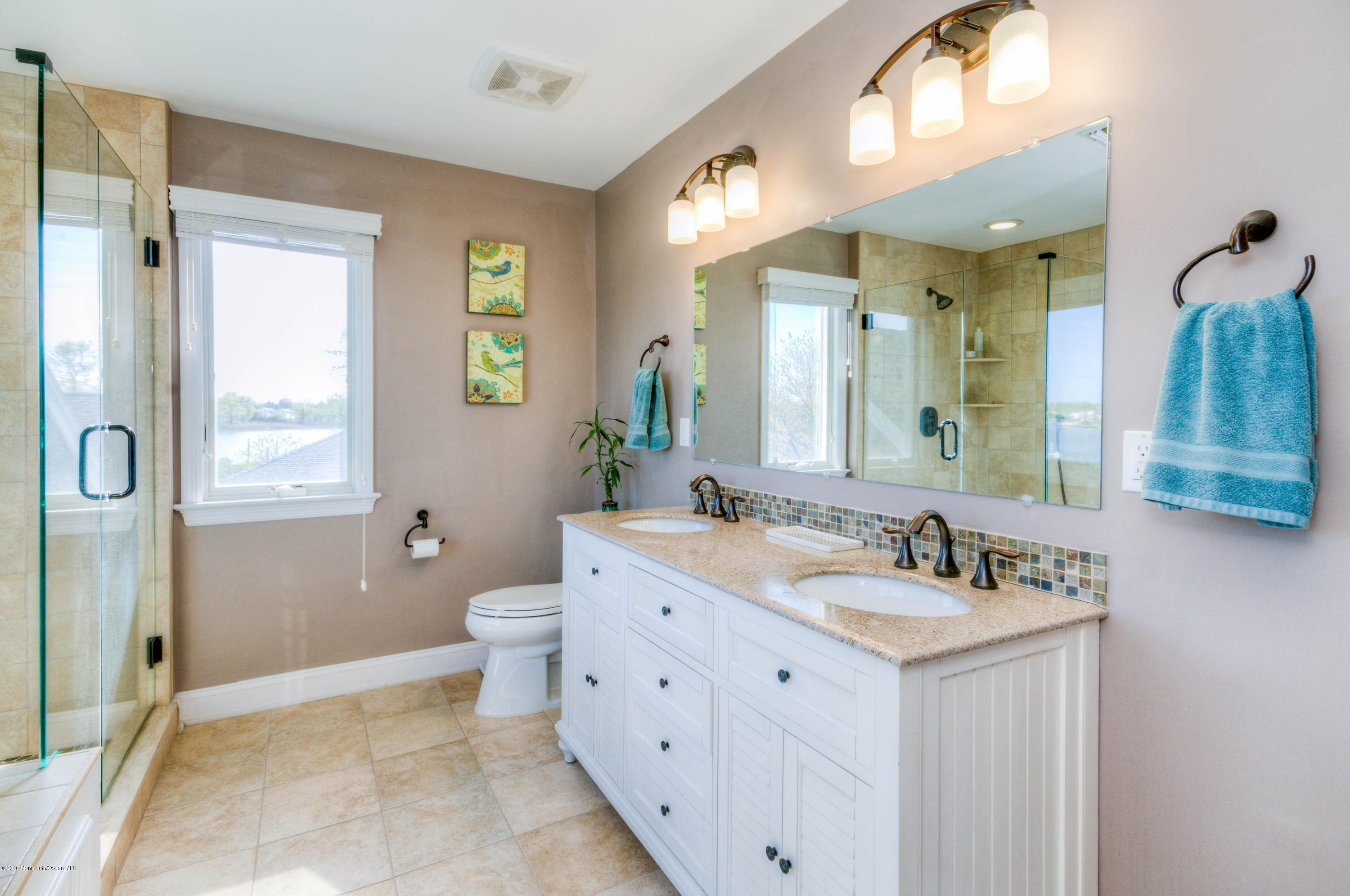 68 Rivers Edge Drive Little Silver, NJ 07739 - Photo 16 of 25 a spacious bathroom with a double vanity sink a mirror and a toilet