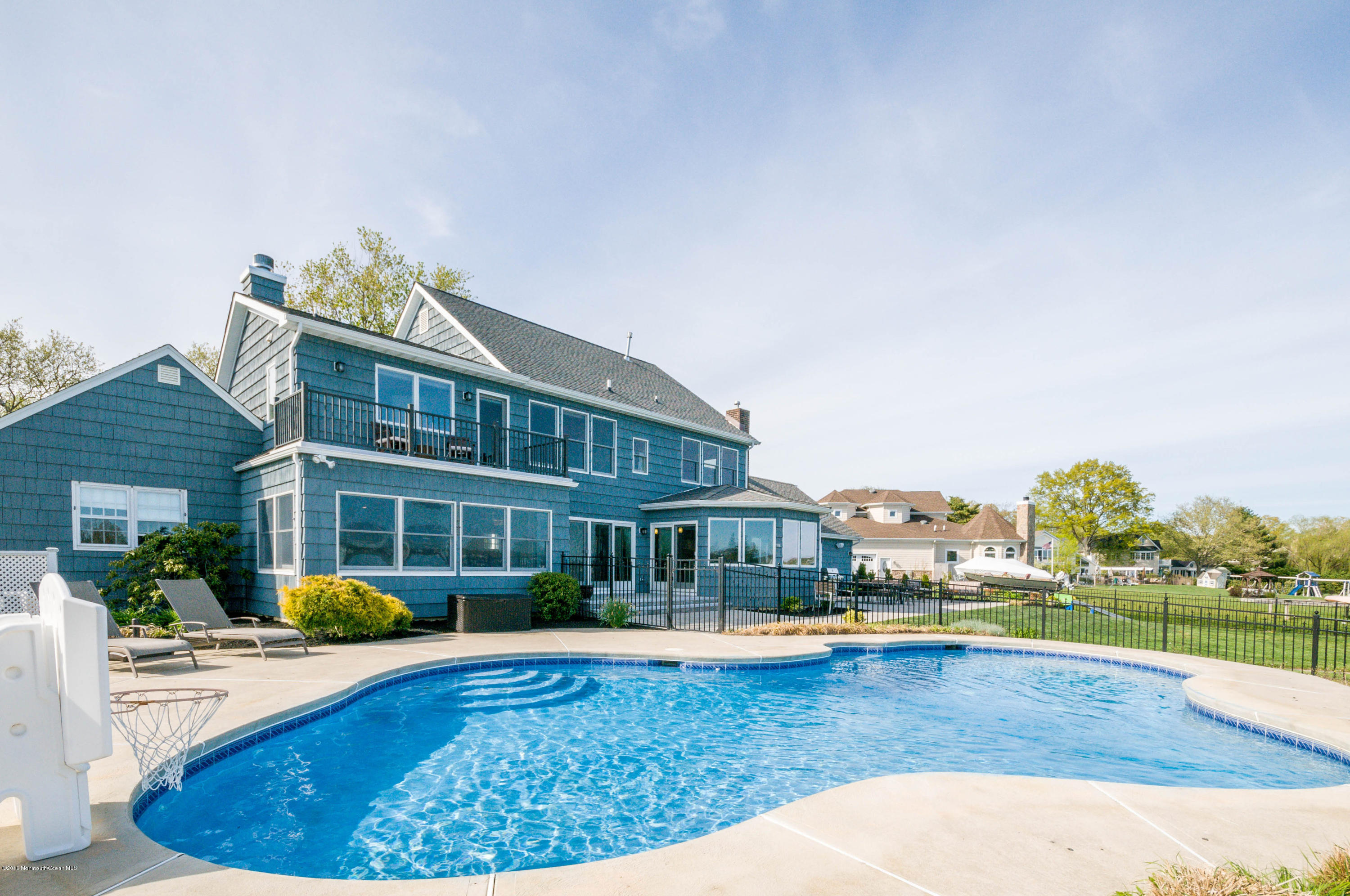 68 Rivers Edge Drive Little Silver, NJ 07739 - Photo 19 of 25 a view of a swimming pool and a chairs and tables in the patio