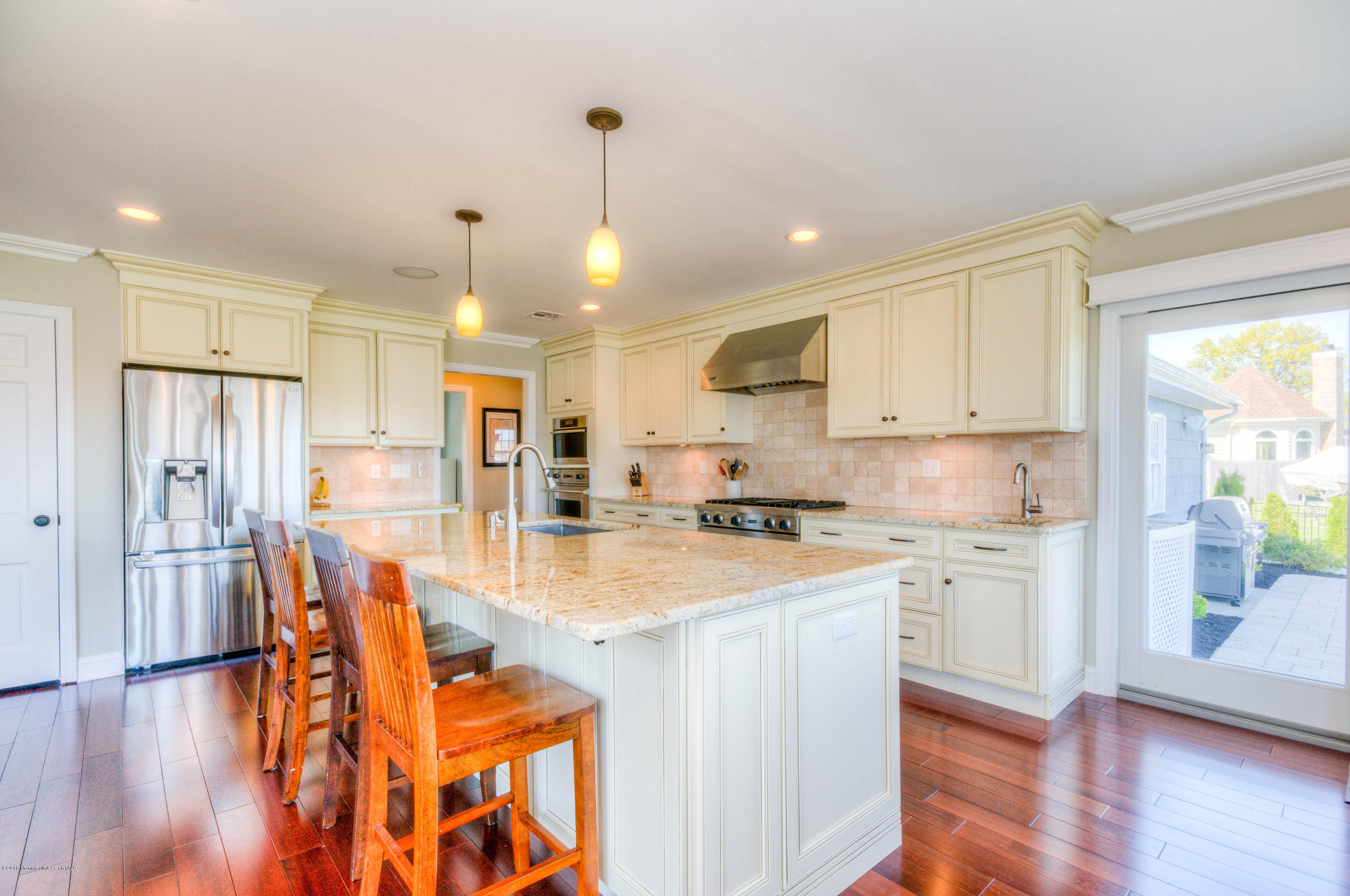 68 Rivers Edge Drive Little Silver, NJ 07739 - Photo 5 of 25 a kitchen with stainless steel appliances kitchen island granite countertop a refrigerator a stove and white cabinets with wooden floor