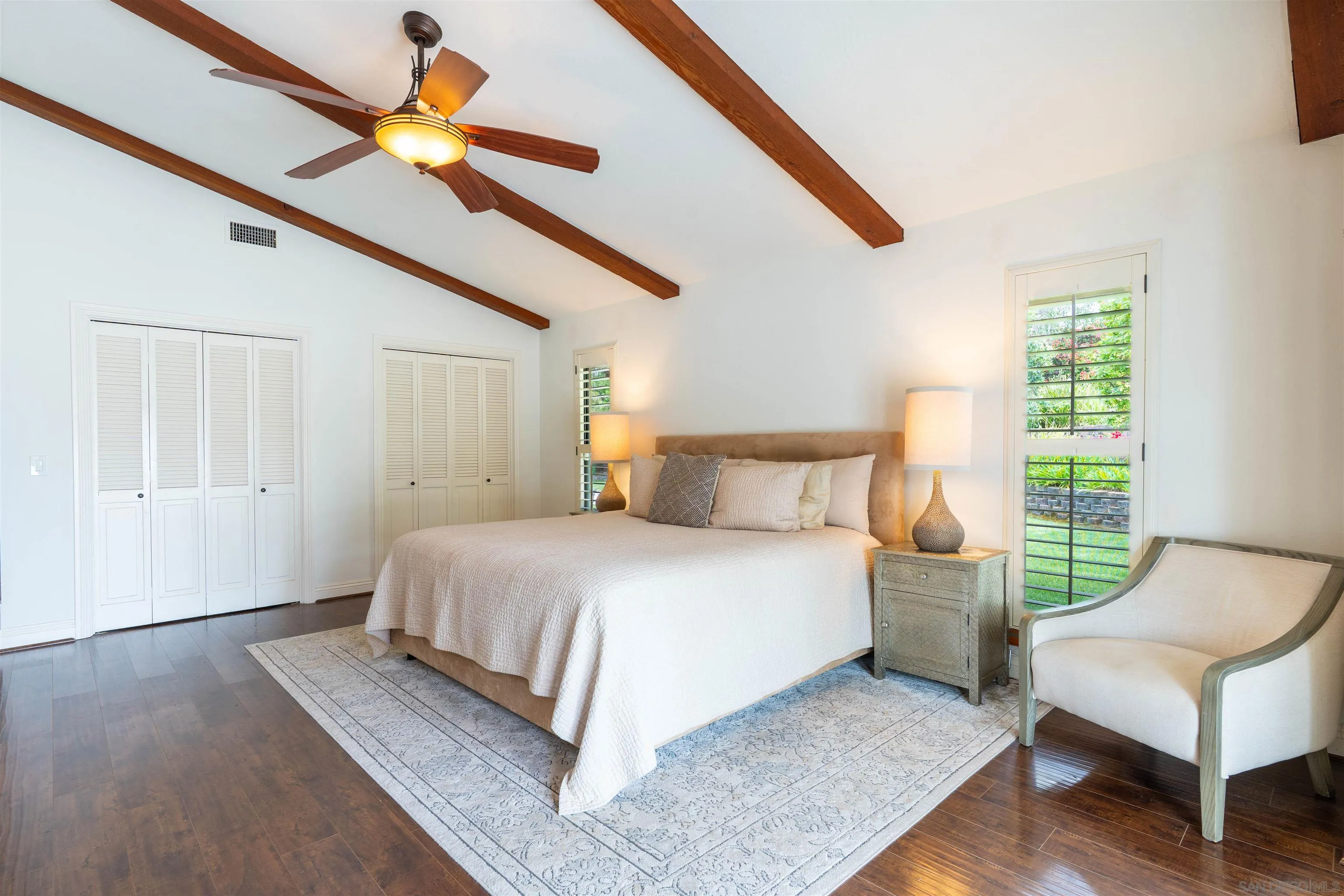 1036 Capra Way Fallbrook, CA 92028 - Photo 17 of 51 a bedroom with a bed a couch and a window