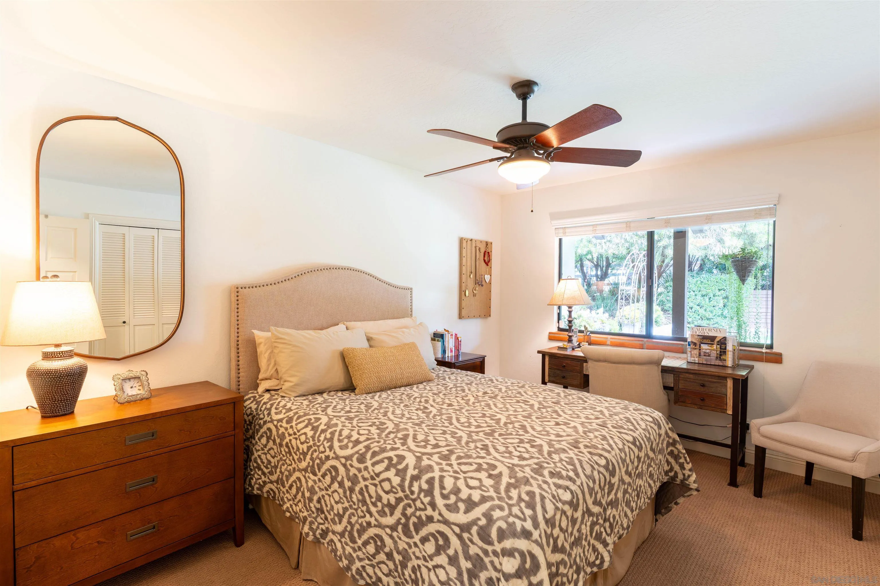 1036 Capra Way Fallbrook, CA 92028 - Photo 22 of 51 a bedroom with a bed and a chandelier