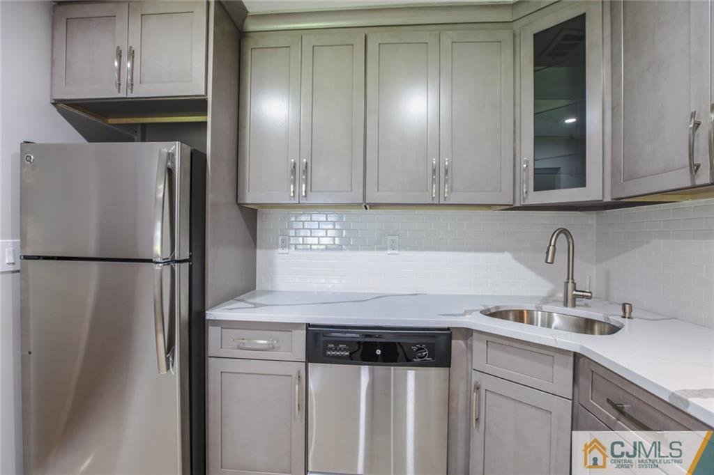 3002 Hana Road Edison, NJ 08817 - Photo 3 of 15 a kitchen with a refrigerator and cabinets