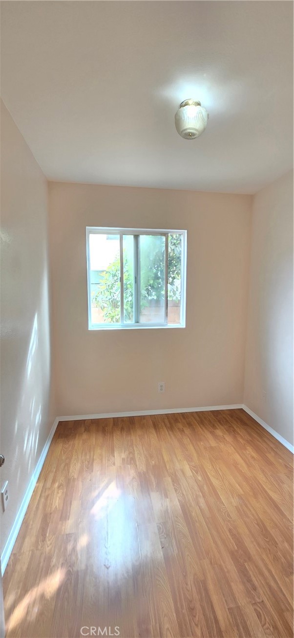 1060 Cherry, Unit A & B Long Beach, CA 90813 - Photo 46 of 63 an empty room with wooden floor and windows