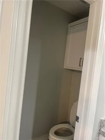 a white toilet sitting next to a shower