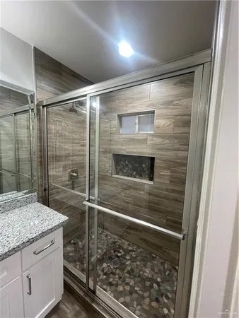 a bathroom with a shower and a sink