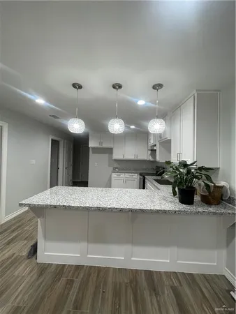 a large kitchen with kitchen island a sink stainless steel appliances and cabinets