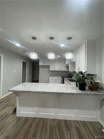 a large kitchen with kitchen island a sink stainless steel appliances and cabinets