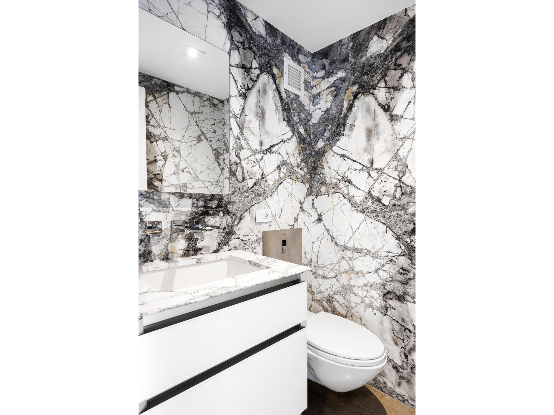 135 West 70th Street, Unit 10C Manhattan, NY 10023 - Photo 7 of 24 a bathroom with a sink toilet and a mirror