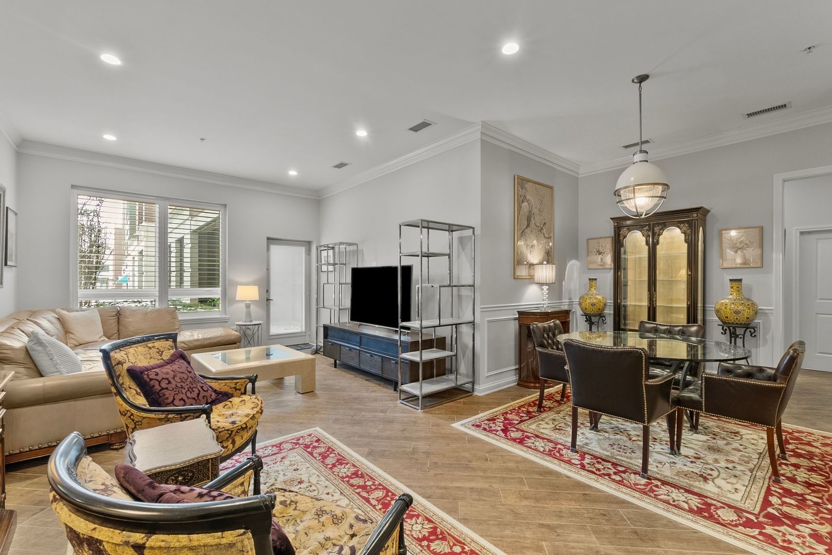 1000 Village Center Drive, Unit 102 Burr Ridge, IL 60527 - Photo 12 of 28 a living room with furniture a flat screen tv and a table