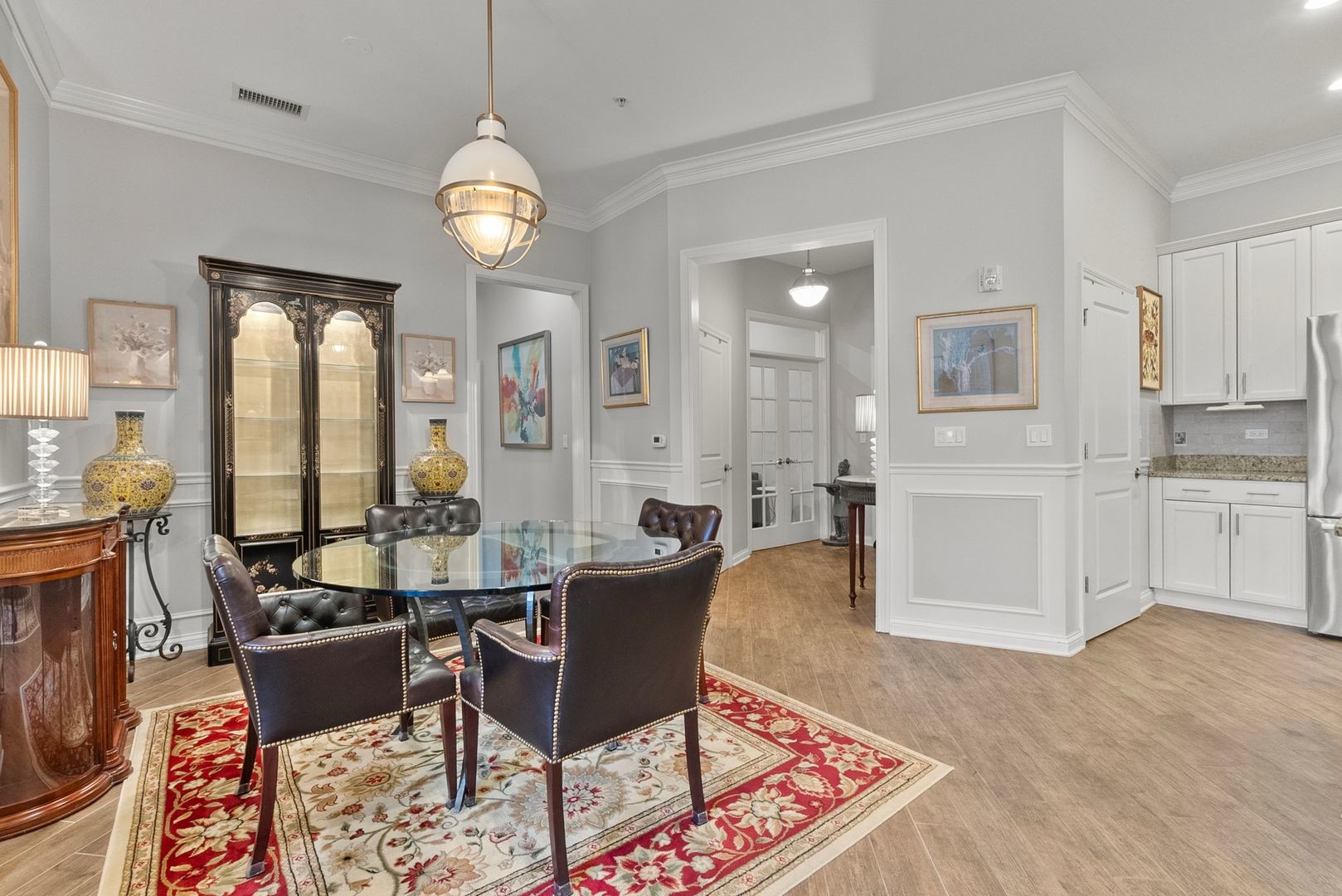 1000 Village Center Drive, Unit 102 Burr Ridge, IL 60527 - Photo 16 of 28 a living room with furniture a large window and a dining table with wooden floor