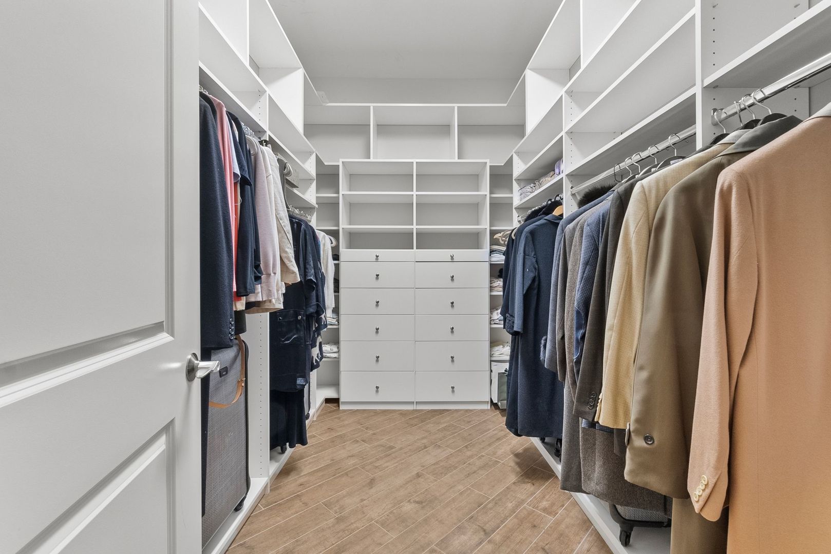 1000 Village Center Drive, Unit 102 Burr Ridge, IL 60527 - Photo 21 of 28 a view of walk in closet with clothes and shoes