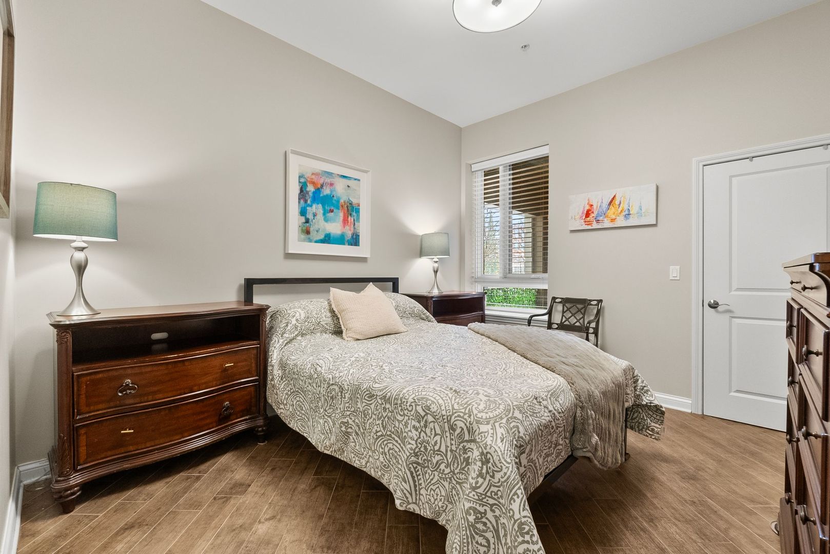 1000 Village Center Drive, Unit 102 Burr Ridge, IL 60527 - Photo 25 of 28 a bedroom with a bed and a night stand