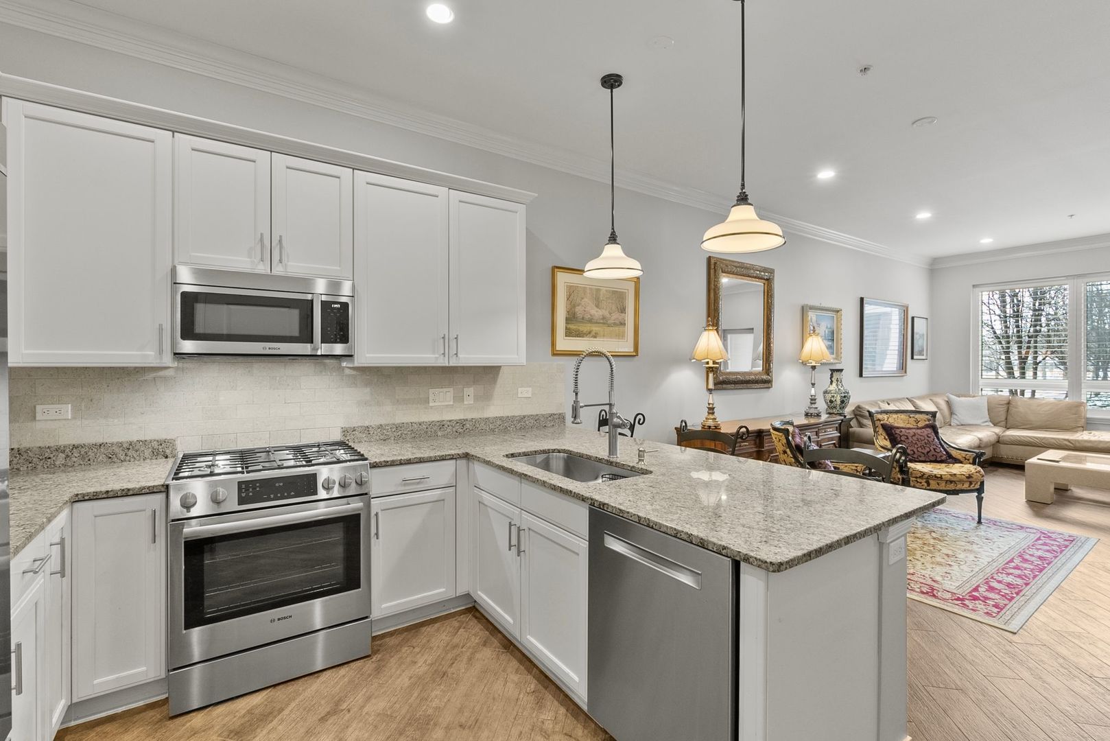 1000 Village Center Drive, Unit 102 Burr Ridge, IL 60527 - Photo 5 of 28 a kitchen with a sink stove and microwave