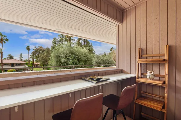a view of a dining room with furniture and a window