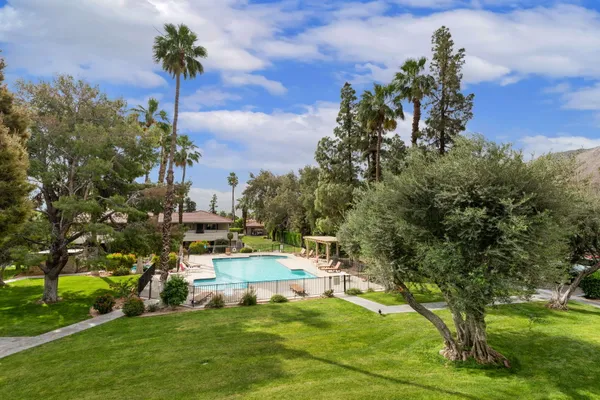 a view of a swimming pool with a yard