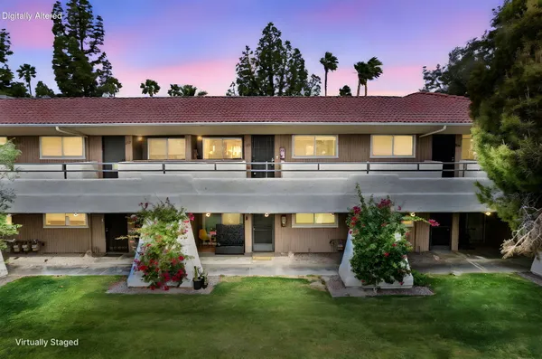 a front view of a house with a garden and plants