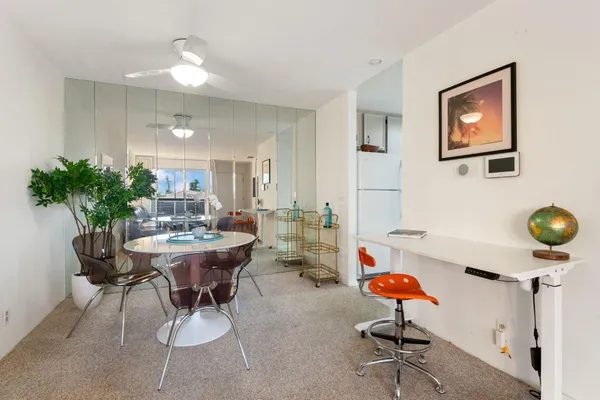 a living room with furniture and flowers