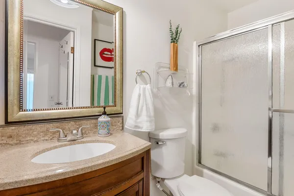 a bathroom with a sink toilet and shower