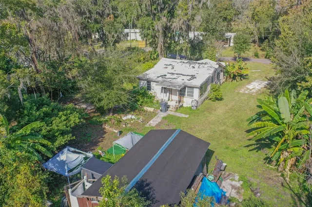 an aerial view of a house with yard swimming pool and outdoor seating