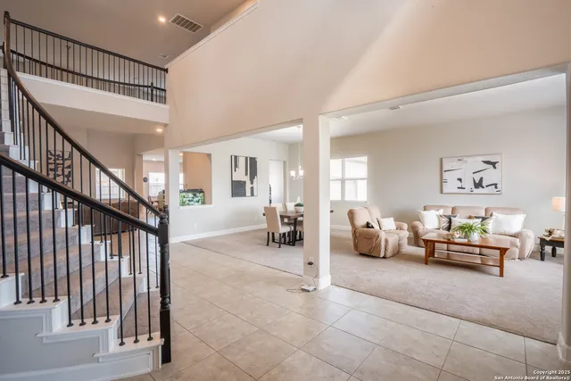 a living room with furniture kitchen view and a table