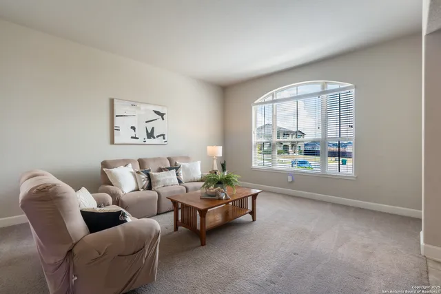 a kitchen with stainless steel appliances kitchen island granite countertop a refrigerator and a stove top oven with wooden floor