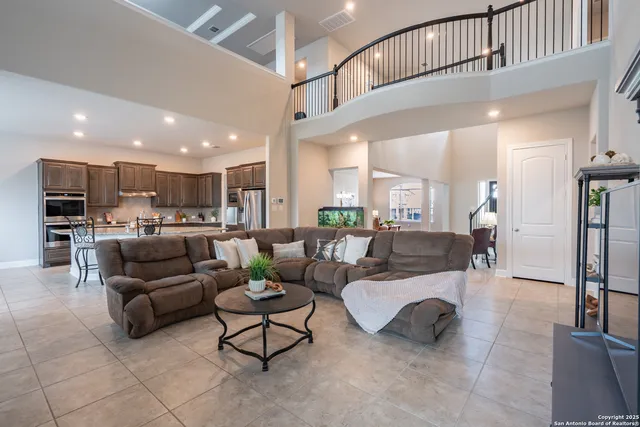 a large room with kitchen island a table and chairs