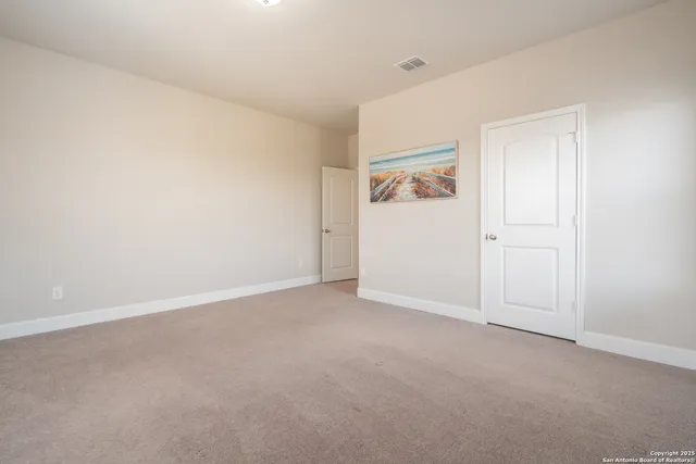 a living room with furniture and dresser