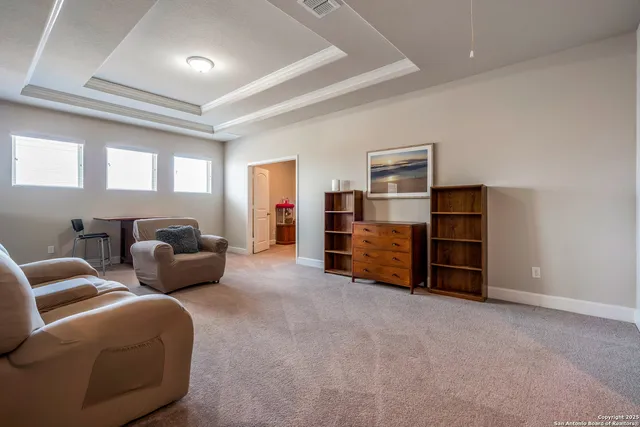 a kitchen with a white cabinets and a refrigerator