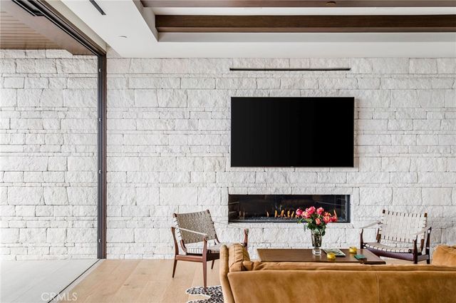 a living room with a fireplace and a flat screen tv